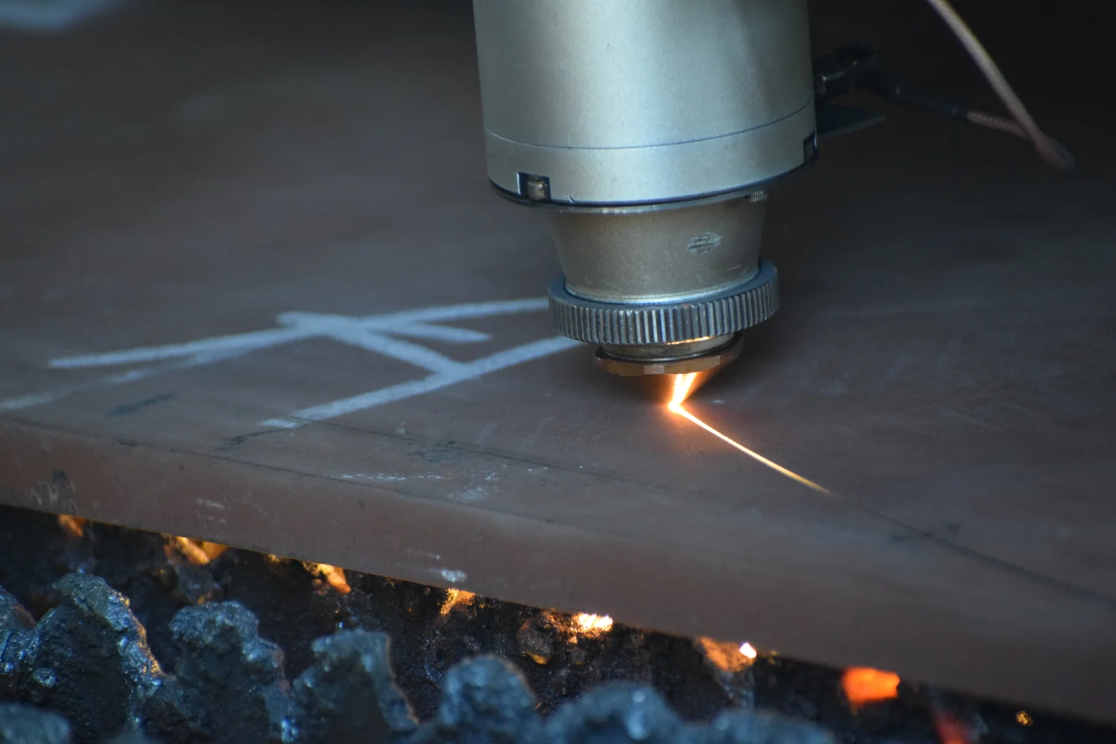 CNC laser cutting machine marking and cutting a steel plate