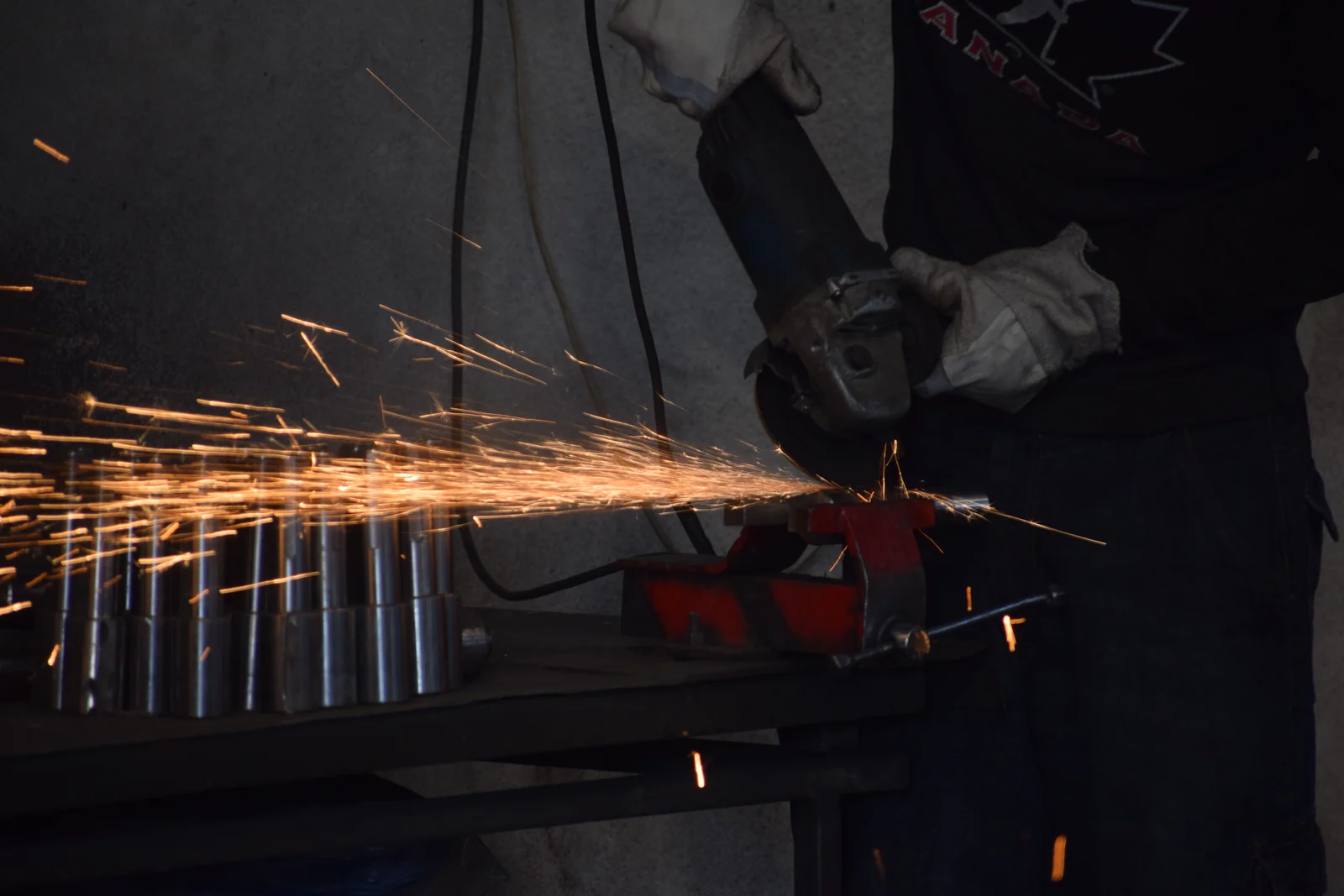 Angle grinder cutting steel rods and throwing a stream of sparks