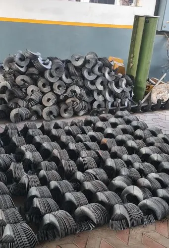 Heaps of steel helical screw flights ready for auger assembly