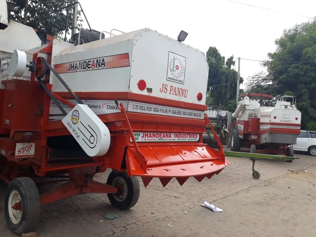 Jhandeana straw reaper combine in red and white